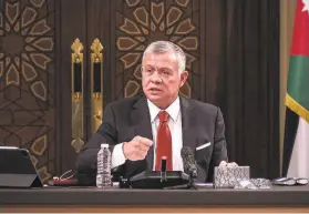  ?? Jordanian Royal Palace ?? King Abdullah II speaks to lawmakers last month in Amman. The king’s half brother, Prince Hamzah, says he has been placed under house arrest.