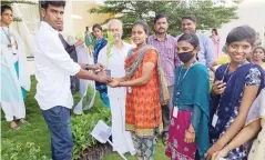  ?? ?? Vellore green champion award winner handing over 500 saplings to students of a private arts college in Gudiyattam on Saturday