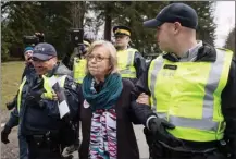  ?? The Canadian Press ?? Federal Green party Leader Elizabeth May is arrested by RCMP officers after joining protesters outside Kinder Morgan’s facility in Burnaby on Friday. They were protesting the Trans Mountain pipeline expansion.