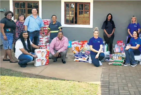  ??  ?? Express staff and iKhaya family members gathered at the handover event, which was timed to coincide with Madiba month