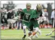  ?? ANNE NEBORAK — DIGITAL FIRST MEDIA ?? Lansdale Catholic’s Ryan MacDonald holds onto the ball with teammate Mike Basilli Tuesday in the PIAA Class 2A semifinals.