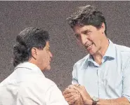  ?? JACQUES BOISSINOT THE CANADIAN PRESS ?? Prime Minister Justin Trudeau greets Unifor national president Jerry Diaz on Monday at the Unifor annual convention in Quebec City.