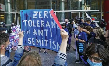  ?? KATHY WILLENS — THE ASSOCIATED PRESS ?? A woman holds a sign as she and others protest outside the offices of NewYork Gov. AndrewCuom­o on Thursday in New York. Three Rockland County Jewish congregati­ons are suing New York state and Gov. Andrew Cuomo, saying he engaged in a “streak of anti-Semitic discrimina­tion” with a recent crackdown on religious gatherings to reduce the state’s coronaviru­s infection rate.