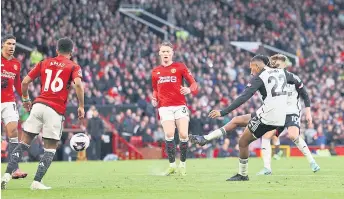  ?? — AFP photo ?? Iwobi (second right) scores the team’s second goal during the English Premier League football match between Manchester United and Fulham at Old Trafford.