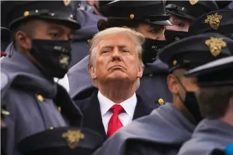  ??  ?? Surrounded by Army cadets, President Donald Trump watches the first half of the 121st Army-Navy Football Game in Michie Stadium at the United States Military Academy, Saturday, Dec. 12, 2020, in West Point, N.Y. (AP Photo/Andrew Harnik)