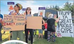  ??  ?? MENIE Campaigner­s gather outside the main entrance to the president’s resort