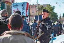  ?? AFP ?? A policeman keeps watch as Syrian-Kurds protest against Turkey’s threats against their region, in Qamishli, on Sunday.