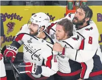  ?? ETHAN MILLER/GETTY IMAGES ?? Alex Ovechkin, right, waits for Thursday’s final buzzer with teammates Chandler Stephenson, left, and Nicklas Backstrom.