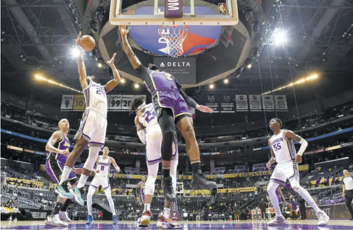  ?? AFP) (Photo: ?? Buddy Hield (left) of the Sacramento Kings drives to the basket during the game against the Los Angeles Lakers at Staples Center in Los Angeles, California, on Friday.