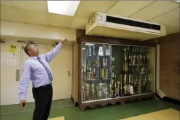  ?? AP photo ?? Jim Hill High School principal Bobby Brown points out one of the outdated air-conditioni­ng units that are installed throughout the Jackson, Miss., school on Jan. 12. A litany of infrastruc­ture issues in the nearly 60-year-old school make for tough choices on spending COVID recovery funds on infrastruc­ture or academics.