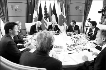  ??  ?? G7 Summit members attend the first working session (from bottom centre) President of the European Commission President Jean-Claude Juncker, Canadian Prime Minister Justin Trudeau, German Chancellor Angela Merkel, Trump, Italian Prime Minister Paolo...