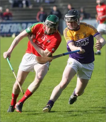  ??  ?? James Peare (Rapparees) is challenged by Faythe Harriers defender Cormac Byrne.