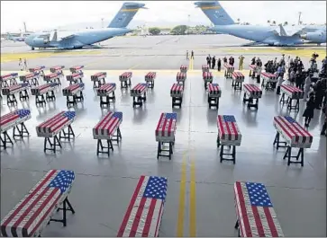  ?? Ronen Zilberman AFP/Getty Images ?? CASES CONTAINING what North Korea says are remains of U.S. soldiers appear at a repatriati­on ceremony at Joint Base Pearl Harbor-Hickam in Honolulu. One set of dog tags was commingled with the remains.