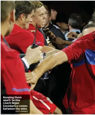  ?? GETTY IMAGES ?? Keeping them apart: Serbia coach Dejan Govedarica comes between the sides