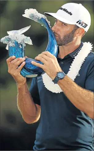  ?? Picture: AFP ?? THE CHAMP: Dustin Johnson with the winner’s trophy after the final round of the Tournament of Champions at the Plantation Course in Kapalua, Hawaii