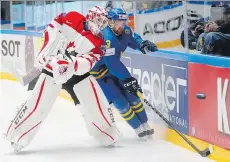  ?? DMITRI LOVETSKY/THE ASSOCIATED PRESS ?? Sweden’s Mattias Ritola fights for the puck with Team Canada goaltender Cam Talbot at the world hockey championsh­ip in St. Petersburg, Russia, on Thursday.