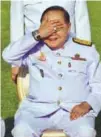  ??  ?? Prawit covers his eyes, displaying a watch he is wearing, during a photo call last month.