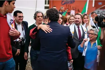  ?? — AFP file photos ?? Andre Ventura, leader of the far-right party Chega (centre) kisses Chega deputy Rita Matias during a rally in Barreiro.