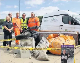  ??  ?? The North West Leicesters­hire District Council environmen­tal protection team with their mock fly-tip at Donington Services.