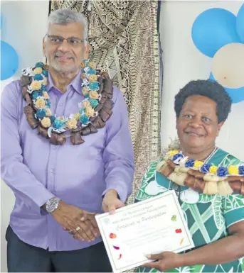  ?? Photo: Simione Haravanua ?? Hydroponic­s graduate Ulamila Akesa receiving her certificat­e from the President of the Fiji Muslim League Hafizud Khan during the Fiji Muslim League’s Makoi Women’s Vocational Training Centre graduation on September 13, 2018.