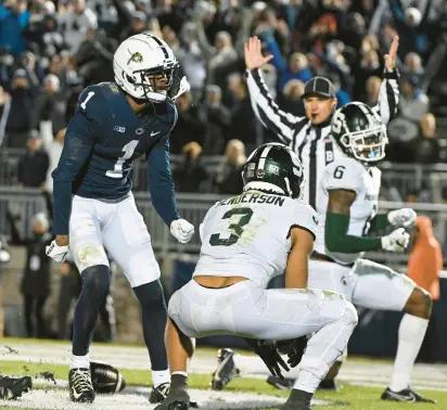  ?? BARRY REEGER/AP ?? Penn State wide receiver KeAndre Lambert-Smith, left, celebrates after scoring a touchdown during the second half against Michigan State on Saturday in State College.