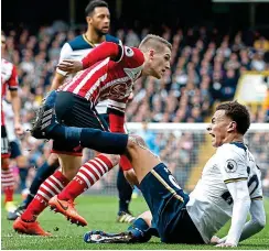  ?? REUTERS/PA ?? Spot of bother: Dele Alli (left) beats Steven Davis to the ball, goes to ground (centre) and successful­ly appeals for a penalty