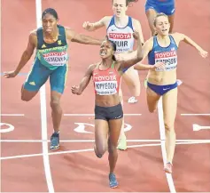  ??  ?? Kipyegon (centre) crosses the finihs line to win the final of the women’s 1,500m athletics event in front of US athlete Jennifer Simpson (right) and South Africa’s Caster Semenya (left) at the IAAF World Championsh­ips at the London Stadium in London. —...