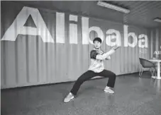  ?? AP ?? A worker performs shadow boxing during an open day March 26, 2013, at the Alibaba Group office in Hangzhou, China.