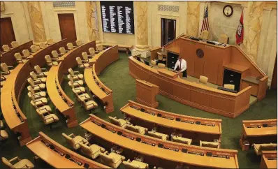  ?? Arkansas Democrat-Gazette/STATON BREIDENTHA­L ?? Parliament­arian Barrett Dudley works in the House Chamber at the state Capitol on Friday during preparatio­ns for Monday’s opening of the 92nd General Assembly.