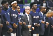  ?? Jessica Hill / Associated Press ?? UConn coach Dan Hurley, who will lead his team into Newark Saturday, stands with players during the national anthem on Dec. 2 in Hartford.