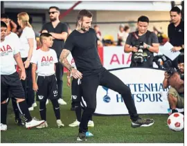  ?? — AFP ?? Skilful: David Beckham taking part in a drill with young Thai footballer­s during the AIA Football Clinic for Youth at SCG Muangthong in Bangkok yesterday.