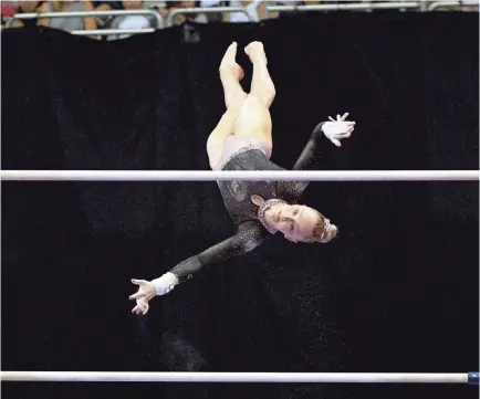  ??  ?? Riley Mccusker performs her uneven bars routine during the U.S. Gymnastics Championsh­ips on Sunday in Kansas City, Mo. Mccusker has one of the most difficult bar routines in the country.