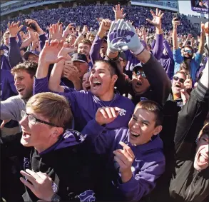  ?? Charlie Riedel / Associated Press ?? Kansas State fans cheer on the field after a game against Oklahoma in 2019.