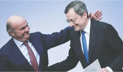  ?? DANIEL ROLAND/AFP VIA GETTY IMAGES ?? Mario Draghi, the departing president of the European Central Bank, right, and the bank’s vice-president Luis de Guindos leave a press conference following the meeting of the Governing Council in Frankfurt, Germany, on Thursday.