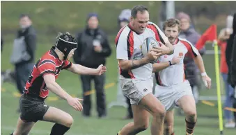  ??  ?? Second row Andy Wordsworth powers forward, supported by Chris Geehan.