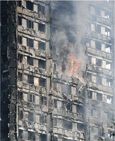  ?? LEON NEAL/ GETTY IMAGES ?? Debris falls from the burning 24 storey Grenfell Tower block in West London Wednesday. The tower was “a disaster waiting to happen,” experts said.