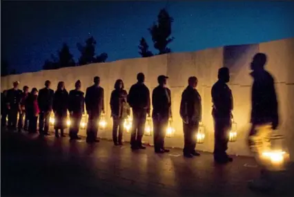  ?? Stephanie Strasburg/ Post- Gazette ?? Families of victims along with park employees carry 40 lanterns, one for each victim of the 9/ 11 crash of Flight 93, on Sept. 10, 2017, at the Flight 93 National Memorial near Shanksvill­e. This year, according to the memorial website, the observance will be private in accordance with the victims’ families’ wishes and health guidelines.