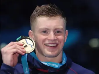  ??  ?? Peaty with his gold medal on the podium (Getty)