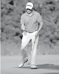  ?? AP Photo/Michael Dwyer ?? n Justin Thomas reacts after sinking his putt on the 16th hole during the final round of the Dell Technologi­es Championsh­ip golf tournament Sept. 4 at TPC Boston in Norton, Mass.