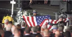  ?? Brian A. Pounds / Hearst Connecticu­t Media ?? State troopers fold the flag from the casket of fellow trooper Sgt. Brian Mohl during his funeral service at the Xfinity Theatre in Hartford on Thursday.