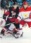  ??  ?? WHL forward Rourke Chartier and Russia defenceman Kirill Tsulygin battle for position in Kamloops on Tuesday.