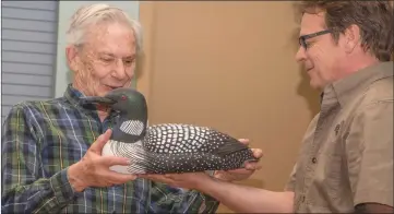  ??  ?? Peter Wade, left, was honoured at the annual general meeting of Renaissanc­e Lacbrome for his enduring and extraordin­ary contributi­on toward the health of the lake and wetlands that serve to keep the water clean. He received a magnificen­t hand-carved...