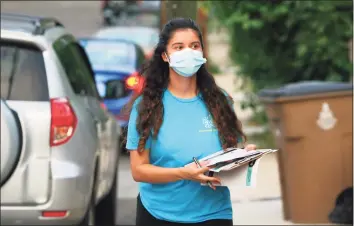  ?? Christian Abraham / Hearst Connecticu­t Media ?? Community Health Care worker Beverly Reyes, with Family Centers of Stamford, goes door-to-door to encourage people to get the vaccine if they haven't already along Williams Street in Stamford last week.