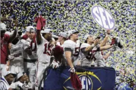  ?? AJ REYNOLDS — ASSOCIATED PRESS ?? Alabama players celebrate after a winning the SEC championsh­ip Dec. 1 in Atlanta.