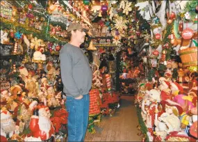  ?? Leslie Hutchison / Hearst Connecticu­t Media ?? Ron Merriman looks at the holiday display which is almost almost certainly going to be the last time the renowned Christmas House on Main Street will be decorated for tours.