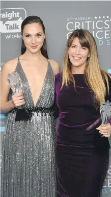  ?? MATT WINKELMEYE­R/ GETTY IMAGES ?? Actor Gal Gadot, left, and director Patty Jenkins pose with the See Her award and Best Action Movie award for Wonder Woman during the Critics’ Choice Awards Thursday night.