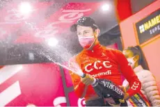  ??  ?? Team CCC rider Czech Republic's Josef Cerny celebrates with a bottle of champagne on the podium after winning the 19th stage of the Giro d'Italia 2020 cycling race.