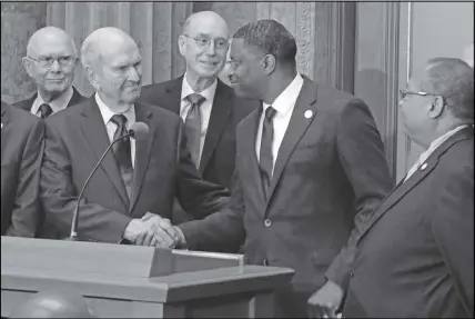  ?? AP PHOTO ?? Mormon church president Russell M. Nelson shakes hands with Derrick Johnson, president of the NAACP, during a news conference in Salt Lake City.