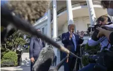  ?? AP file ?? MEDIA CRUSH: President Trump speaks with reporters as he walks to Marine One on Wednesday on the South Lawn of the White House, in Washington, D.C.