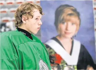  ?? LEAH HENNEL/POSTMEDIA NEWS ?? Tanner Fitzpatric­k skates past a photo of Marit McKenzie during the Marit Cup charity tournament in Calgary on Aug. 26, 2014. Fitzpatric­k received McKenzie’s heart in a transplant when she died in 2013.